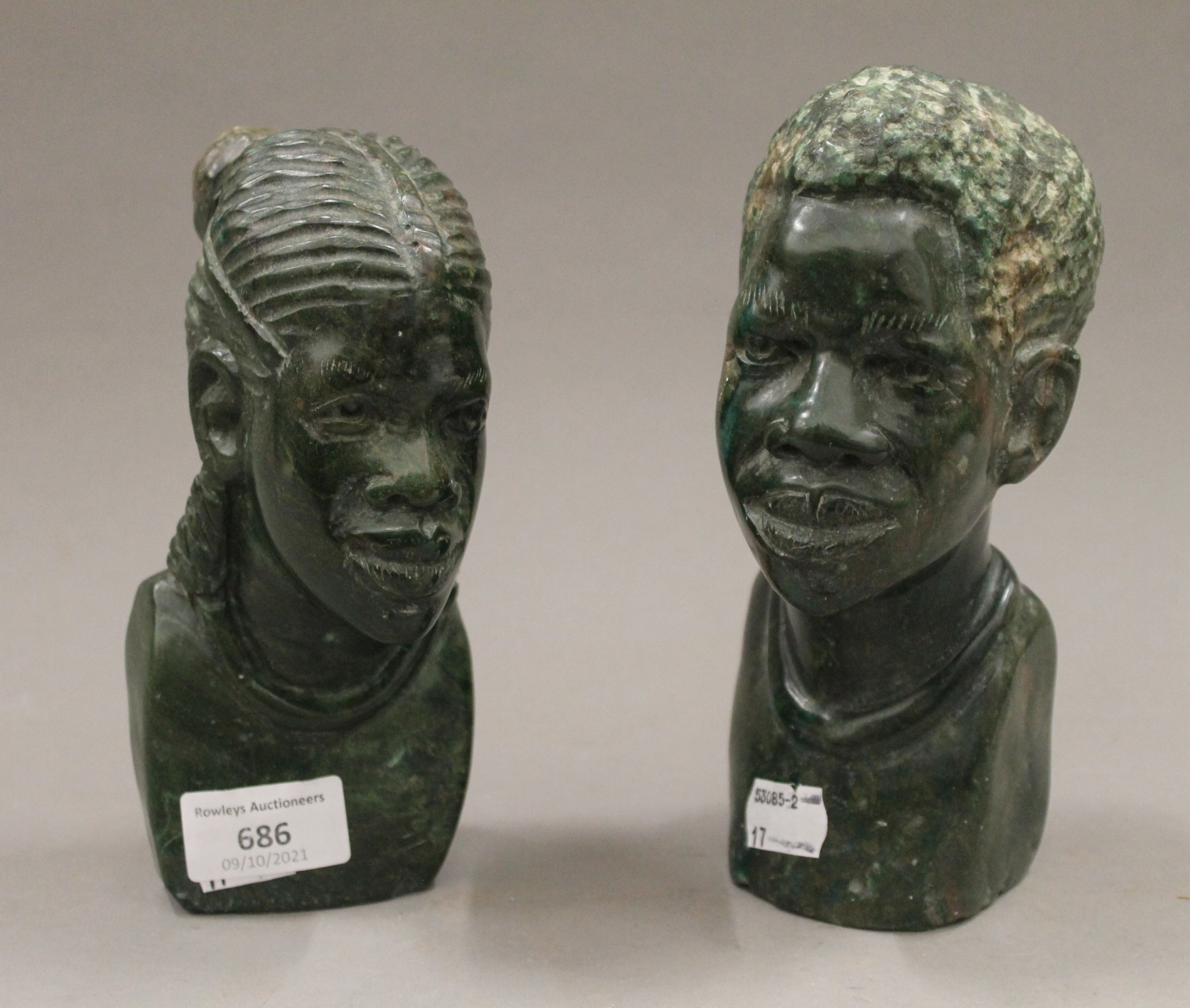 A pair of African carved stone busts. The largest 19.5 cm high.