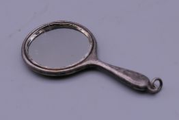 A silver miniature hand mirror. 6.5 cm long.