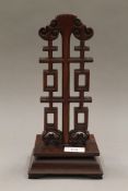 A Chinese carved hardwood wig stand. 30 cm high.