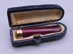 A 9 ct gold mounted cigarette holder, cased. 4.5 cm long.