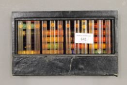 A leather case of Colourmans mixing oils and powders.