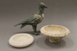 A bronze model of a bird, an alabaster tazza and an alabaster ash tray. The former 24 cm high.