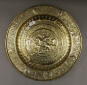 A brass charger depicting George and the Dragon. 44.5 cm diameter.