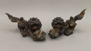 A pair of Chinese bronze fo dogs. The largest 29 cm long.