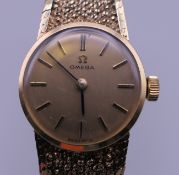 A 9 ct gold ladies Omega wristwatch. 25.7 grammes total weight.