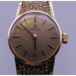 A 9 ct gold ladies Omega wristwatch. 25.7 grammes total weight.