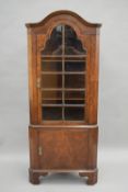 A 20th century walnut corner cabinet. 167 cm high.