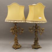 A pair of gilt metal candelabra, converted to table lamps. Each 45 cm high excluding shade.