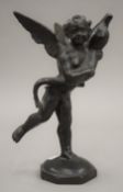 An antique patinated bronze model of a cherub holding a dolphin. 22 cm high.