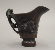 A Chinese carved wooden libation cup. 10 cm high.