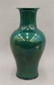 A Chinese green porcelain vase, with drilled base. 43 cm high.