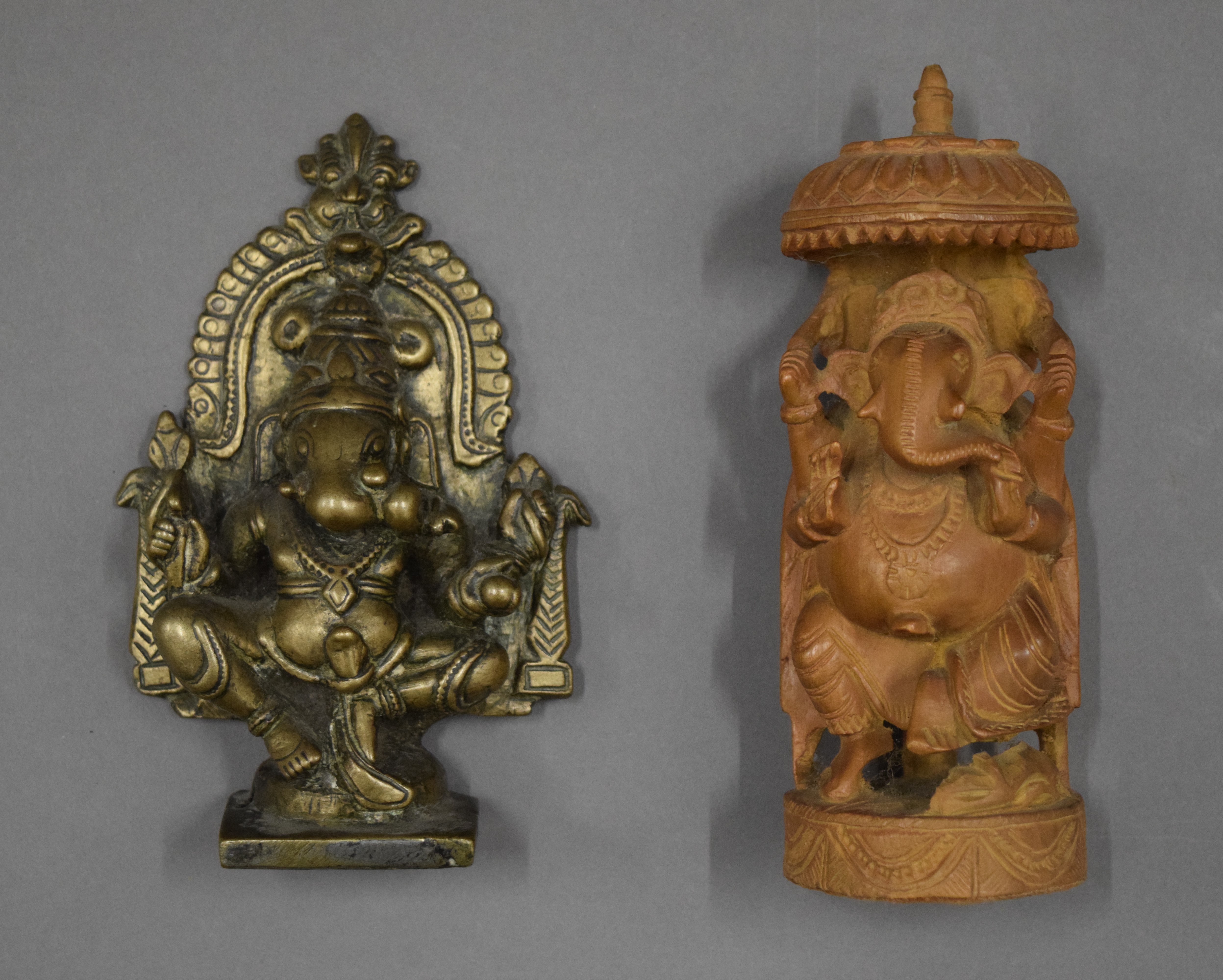 A bronze model of Ganesh and a wooden example. The former 12.5 cm high.