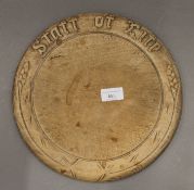 A Victorian Staff of Life carved bread board. 30 cm diameter.