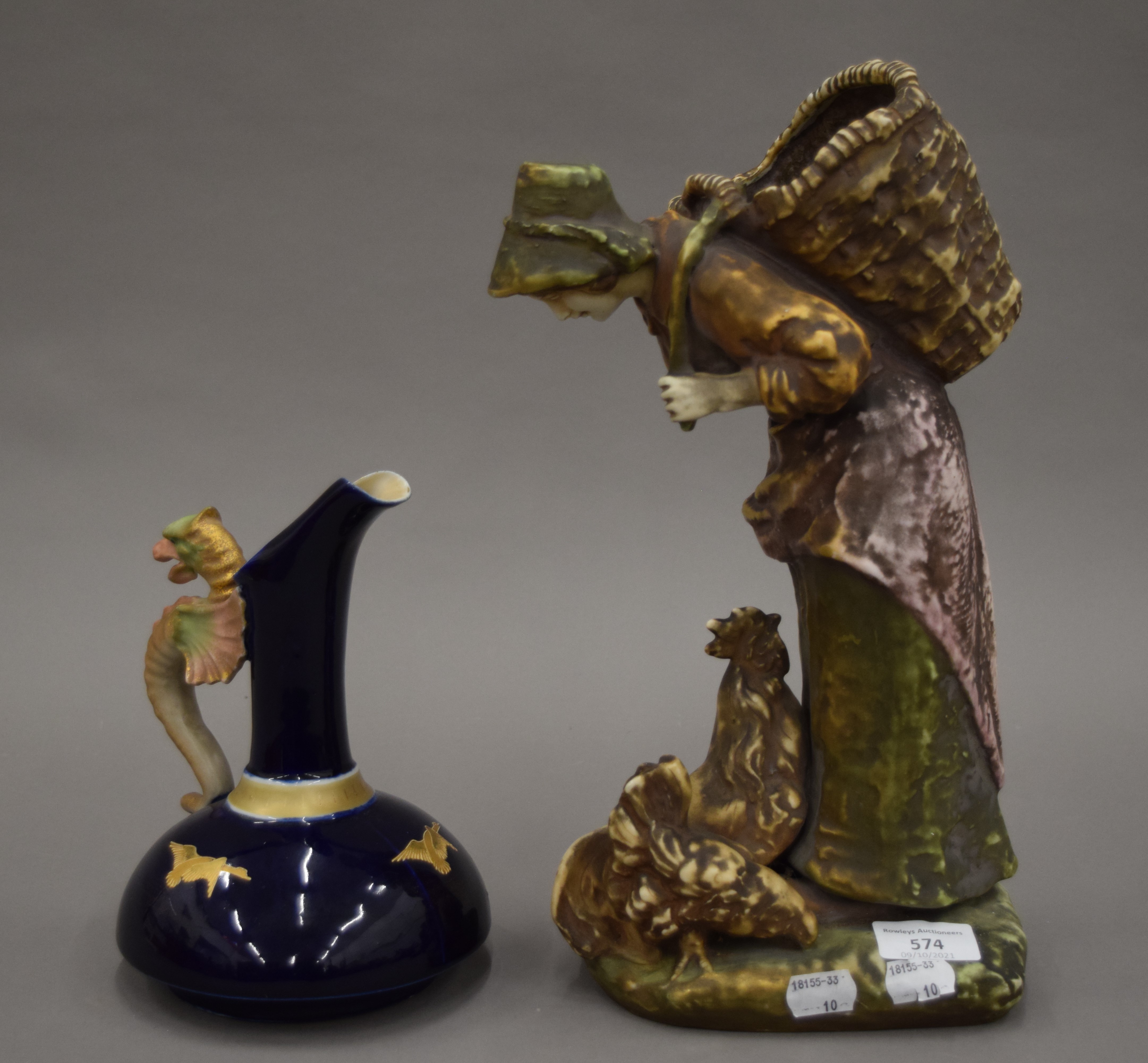 An amphora porcelain figure and a porcelain ewer. The former 34.5 cm high.