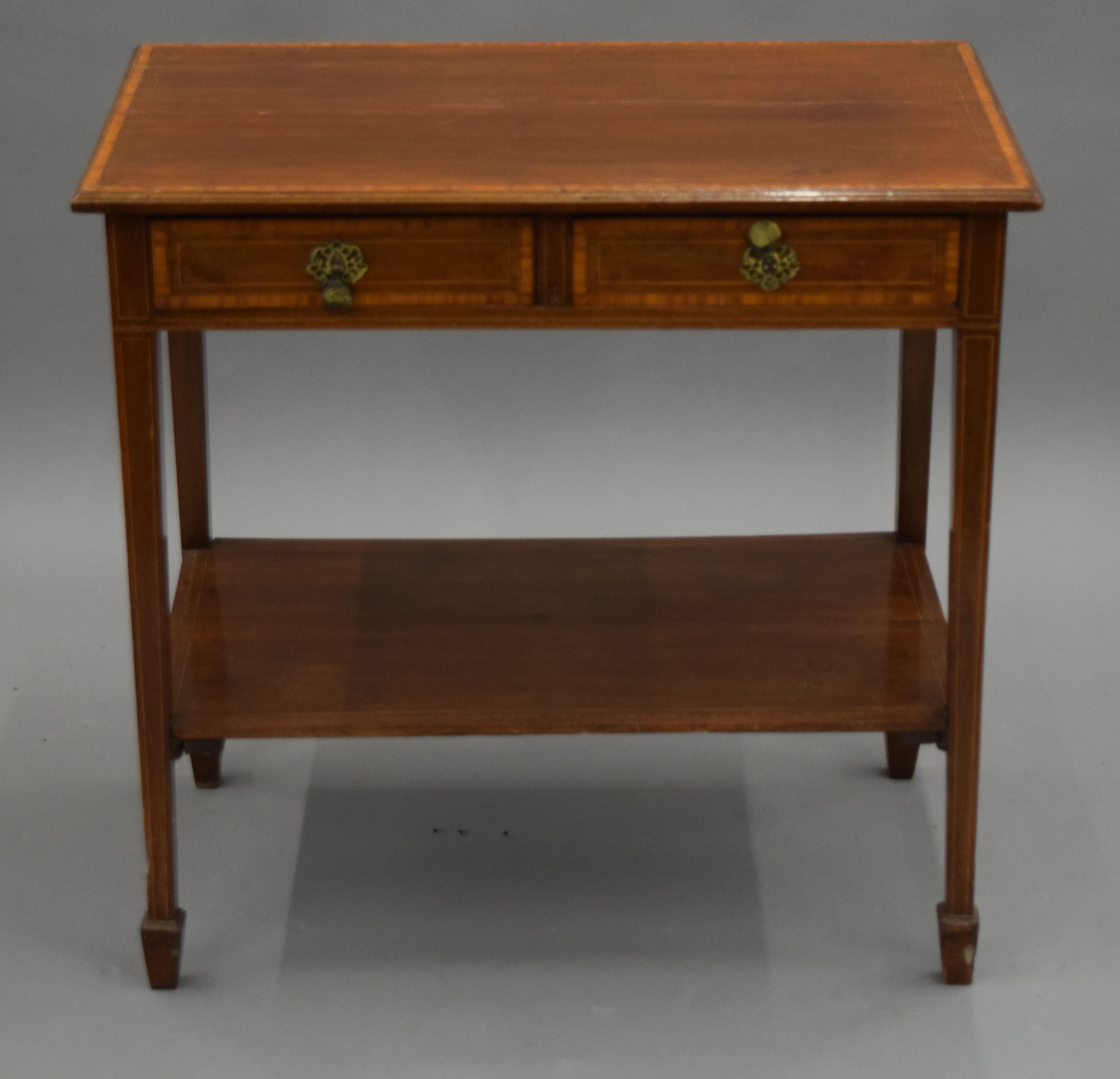 An Edwardian mahogany two drawer side table and a mahogany side table. The former 75.5 cm wide.