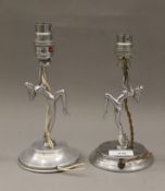 A pair of Art Deco style chrome dancing girl table lamps. Each 20 cm high.