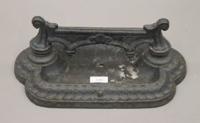 A Victorian cast iron boot scraper. 37.5 cm wide.