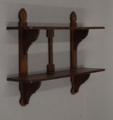 A Victorian oak hanging shelf. 61 cm wide.