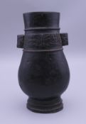 A small Chinese bronze arrow vase. 13 cm high.