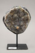 A polished geode on stand. 19.5 cm high overall.