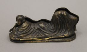 A bronze model of a nude girl under covers. 13.5 cm long.