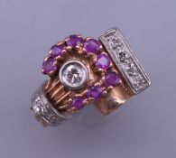 A 14 K gold ruby and diamond ring. Ring size N. 8.3 grammes total weight.