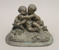 A 19th century patinated bronze model of two putto. 17 cm wide.