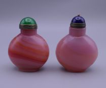 Two hardstone snuff bottles. Each approximately 6 cm high.