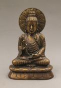 A bronze model of Buddha. 21 cm high.