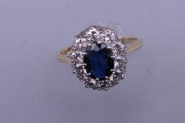 An 18 ct gold sapphire and diamond ring. Approximately 1 carat of diamonds in total. Ring size Q/R.