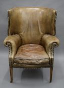 A Georgian style leather upholstered barrel back armchair. 88 cm wide.