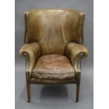 A Georgian style leather upholstered barrel back armchair. 88 cm wide.