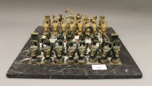 A brass chess set with marble board.