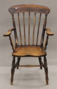 A Victorian elm seated stick back open armchair. 63.5 cm wide.