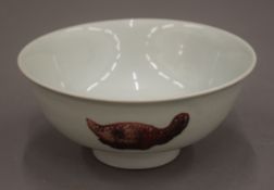 A Chinese porcelain bowl with iron red decoration, the underside with six character mark.