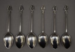 A cased set of six mother-of-pearl handled knives and a cased set of six silver teaspoons.