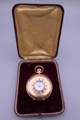 A 9 ct gold half hunter pocket watch. 92 grammes total weight.