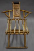 A Chinese elm folding chair. 74.5 cm wide.