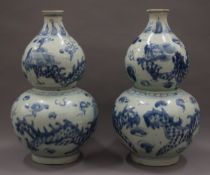 Two Chinese blue and white pottery double gourd vases. Each 37 cm high.