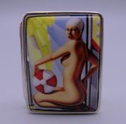 A silver pill box depicting a nude. 3 cm wide.