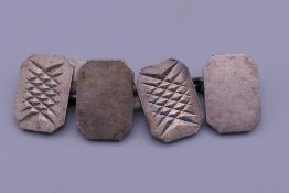 A pair of silver cufflinks.