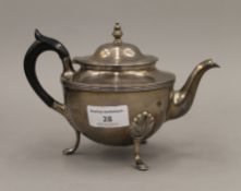 A silver teapot. 13 cm high. 12.9 troy ounces total weight.