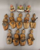 A quantity of carved wooden ethnic musician models. The largest examples approximately 26.5 cm high.