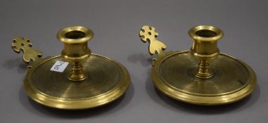 A pair of small brass turned chambersticks. Each 5 cm high.