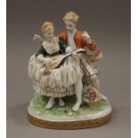 A German porcelain figural group. 12 cm high.