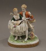 A German porcelain figural group. 12 cm high.