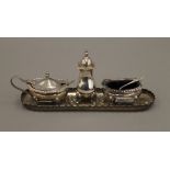 A silver three-piece cruet set and a silver pin tray. The latter 18.5 cm long. 6.7 troy ounces.