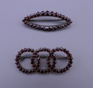 Two garnet brooches. Each approximately 4 cm wide.