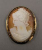 A 9 ct gold antique cameo brooch with safety chain.