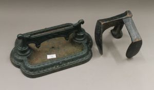 A cast iron boot scraper and a last. The former 39 cm wide.